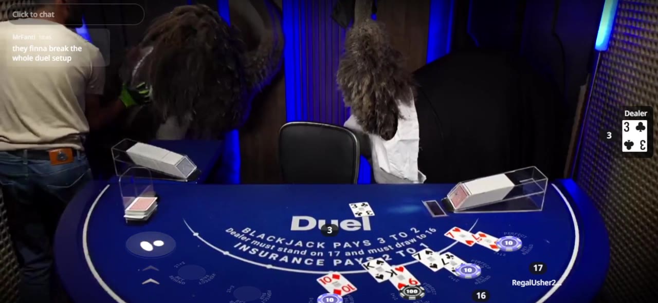 Two ostriches walking behind the dealer during a Duel Blackjack Live stream while the hand continues